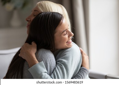 Close Up Grown Up 20s Daughter Hugging Elderly Mother, Multi-generational Family Feeling Love And Giving Support, Women Closed Eyes Cuddling Showing Care, Parent And Children Is Our Life Value Concept