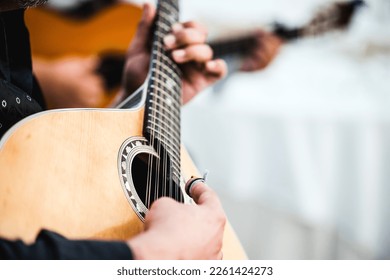 Close up of the guitar of a man playing traditional Portuguese music called fado 