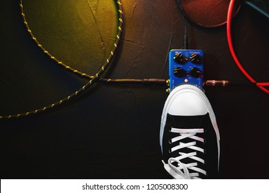 Close up of guitar player foot pressing pedal. Musician uses music effect loop machine. Man in trendy sneakers, his foot playing at stage during concert. Macro view. Copy space - Powered by Shutterstock