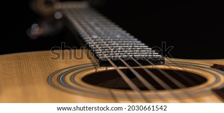 Close up of guitar and strings with shallow depth of field, soft focus.