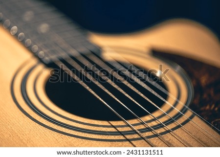Close up of guitar and strings with shallow depth of field, soft focus.