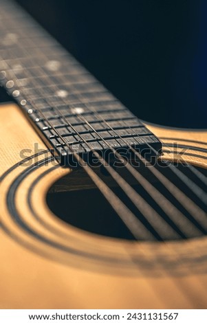 Close up of guitar and strings with shallow depth of field, soft focus.