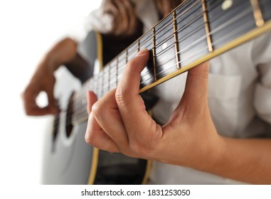 Close up of guitarist hand playing guitar, macro shot. Concept of advertising, hobby, music, festival, entertainment. Person improvising inspired. Copyspace to insert image or text.