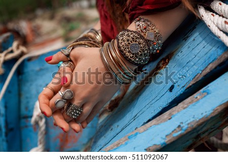 close up of gypsy style woman hands with jewelry