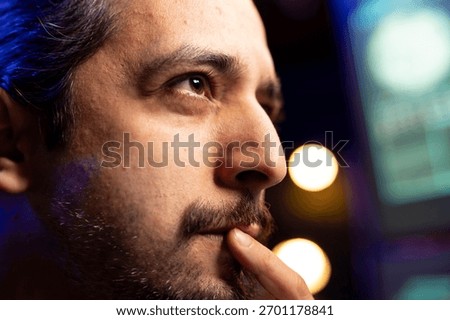 Close up of hacker focused on getting undetectable virus past antivirus protection. Cybercriminal in secret hideout concentrating on developing data mining script to breach firewalls