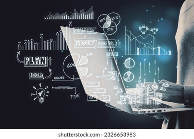 Close up of hacker hands holding and using laptop with creative toned business sketch on dark background. Business strategy and finance concept