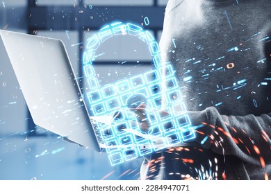 Close up of hacker hands using laptop with glowing safety padlock icon on blurry office interior background. Secure, hacking, protection and web surfing concept. Double exposure