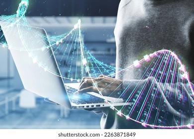 Close up of hacker using laptop with glowing binary code DNA helix on blurry office interior background. Human genome, hacking, phishing and innovative technologies concept. Double exposure