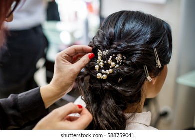 Close Up Of Hair Stylist Making A Braid On Long Brunette Hair In A Beauty Salon. Bridal Hairstyle. Wedding