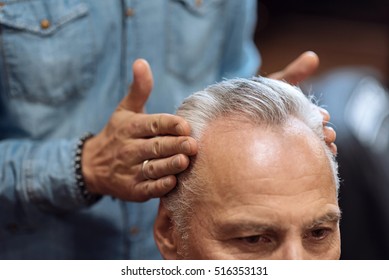 Close Up Of Hairdresser Using Hair Gel On Client