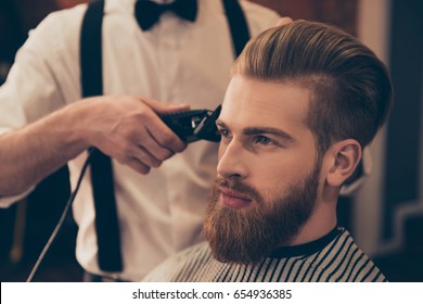 Close Up Of A Hairdresser`s Work For A Handsome Young Guy At The Barber Shop. He Is Doing Styling With The Electric Shaver