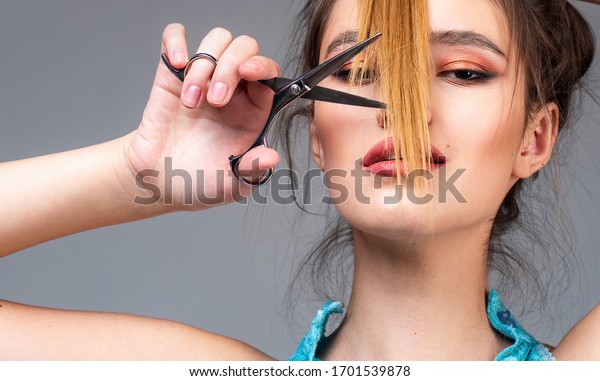 Close up hairstyle with bangs. Blonde girl\
cut forelock. Brunette woman with stylish smooth haircut. Close up\
hairstyle with bangs. Hair care\
concept
