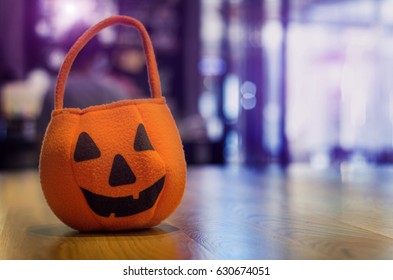 close up halloween bag on wood table and copy space with copy space on purple light on background