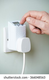 Close Up Of Hand Adjusting Timer Switch In Plug Socket - Shutterstock ID 366048563
