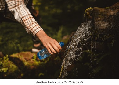 Close up of hand adult young caucasian man pour water at the spring in the forest - Powered by Shutterstock