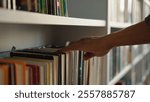Close up hand African American man choose book bookshelf library bookstore student university unrecognizable reader literature textbooks literary bookworm bookcase education learn buyer shopper books