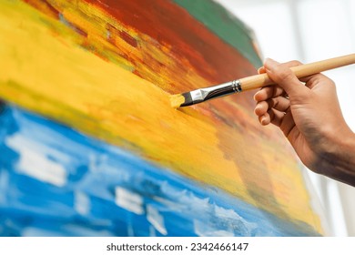 Close up hand Asian woman artist working on painting with brush and variant acrylic color. Female artist painter on canvas in creative studio as art concept - Powered by Shutterstock