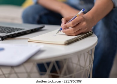 Close Up Hand Of Business Man Holding Pen And Writing To Do List Or Calculated In Book. Writing Work Or Requirment Ideas In Paper On Work Table. Male Hands Holding Pen Making Notes In Notepad