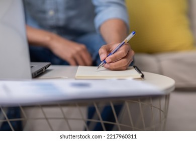 Close Up Hand Of Business Man Holding Pen And Writing To Do List Or Calculated In Book. Writing Work Or Requirment Ideas In Paper On Work Table. Male Hands Holding Pen Making Notes In Notepad