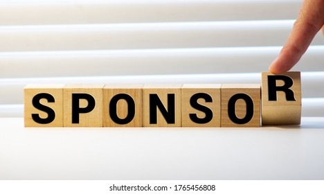 Close Up Hand Of A Businessman Arranging Small Wooden Blocks On The Table For Business Sponsor And Scholarship Concept.