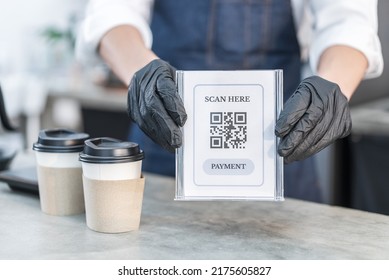 Close Up Hand Of Businessman Owner Hold A Quick And Easy Payment. Handsome Young Male Holding QR Code For To Pay Service For Buy Drink And Food From Barista Waiter In Coffee Shop, New Normal Lifestyle