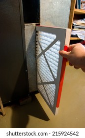 Close Up Of Hand Changing Home Furnace Filter