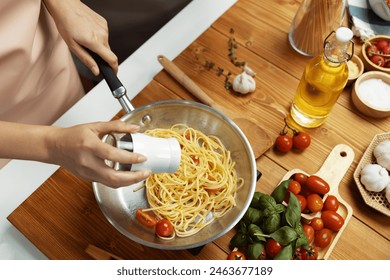 Close up of hand chef influencer cooking spaghetti mix ingredient taking to frying pan, putting seasoning and tasty sauce to make good flavor, Concept of presenting homemade food at studio. Postulate. - Powered by Shutterstock