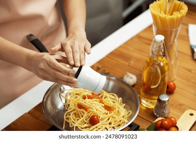 Close up of hand chef influencer cooking spaghetti mix ingredient taking to frying pan, putting seasoning and tasty sauce to make good flavor, Concept of presenting homemade food at studio. Postulate. - Powered by Shutterstock