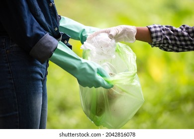 Close up hand children collecting garbage and plastic on the river to dumped into the trash for volunteer charity save environment. Ecology earth Concept - Powered by Shutterstock