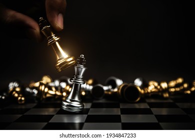 Close up hand choose king chess to challenge battle fighting on chess board concepts of leadership and business strategy and human personal organization risk management. - Shutterstock ID 1934847233