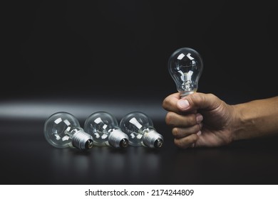 Close Up Hand Choose Light Bulb Or Lamp For Human Resources Or Leadership And Creativity Thinking Idea Motivation Or Vision And Knowledge Learning And Study Or Education Concept.