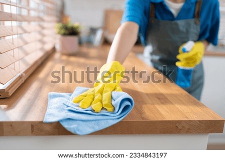 Close up hand cleaning home and wiping with microfiber cloth in kitchen room at home	 Imagine de stoc © 