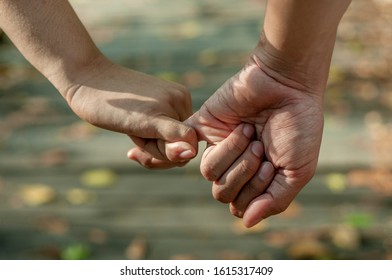  close up of the hand of a couple, hand in hand with finger - Shutterstock ID 1615317409