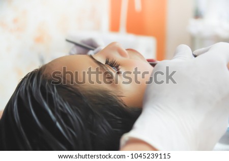 Close up of hand of a dentist during an intervention of a little boy. Dentist Concept in a blurred background