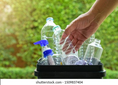 Close up hand dropping plastic bottle into the bin for separating recycle materials from the garbages. Reducing waste by following the green concept. Recycling process. - Shutterstock ID 1509837404