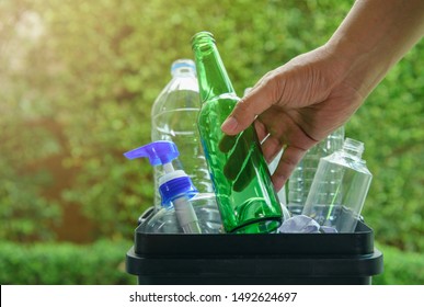 Close up hand dropping plastic and glass bottle into the bin for separating recycle materials from the garbages. Reducing waste by following the green concept. Recycling process. - Shutterstock ID 1492624697