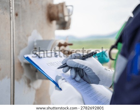 Close up hand engineer Report working  management air pollution reduction, continuous emission monitoring system factory and industry manufacturing. Clean air Eco friendly. Environment sustainable.