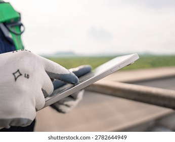 Close up hand engineer using digital tablet management air pollution reduction, continuous emission monitoring system factory and industry manufacturing. Clean air Eco friendly. Environment sustainable