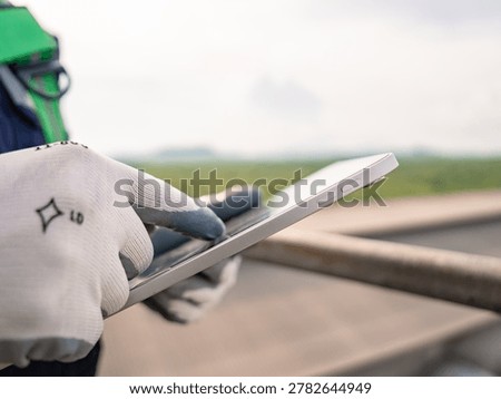 Close up hand engineer using digital tablet management air pollution reduction, continuous emission monitoring system factory and industry manufacturing. Clean air Eco friendly. Environment sustainable