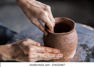 close up of hand forming a clay in workshop - Shutterstock ID 524222467