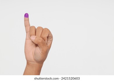 Close up of hand gesture little finger after voting. General elections or Pemilu for the president and government of Indonesia. The finger dipped in purple ink. Isolated image on white background - Powered by Shutterstock