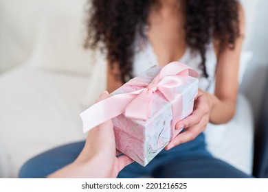 Close Up Of Hand Giving Pretty Gift Wrapped In Pink Bow In Bed