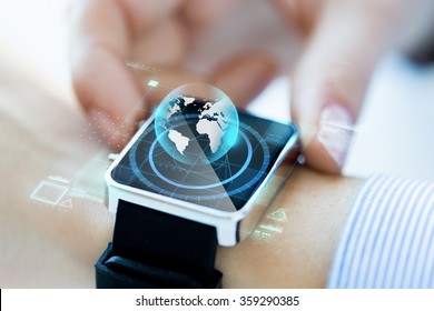 close up of hand with globe hologram on smartwatch
