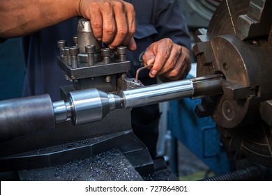 Close Up Hand  Heavy Industrial Worker Is Working On Metal Work Factory Process By Performing Mechanical Turning Operation At Machine For Steel Structure Industry 