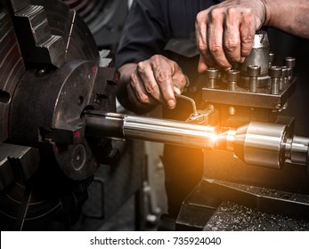 Close up hand  heavy industrial worker is working on metal work factory process by performing mechanical turning operation at machine for steel structure industry  - Powered by Shutterstock