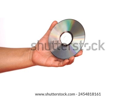 Close up hand hold CD compact disc, DVD, isolated on white background. Concept, tool, equipment for setup or install programs in computer or music, movie for dvd player.                             