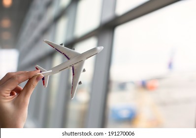 Close Up Hand Holding An Airplane Model