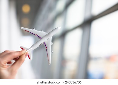 Close Up Hand Holding An Airplane Model At Airport