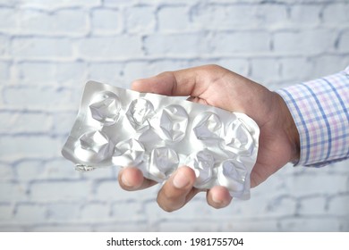 Close up of hand holding blister packs . - Shutterstock ID 1981755704
