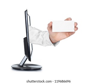 Close Up Of A Hand Holding Business Card Reaching Out Of A Computer Screen On White Background.